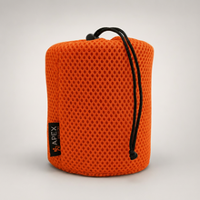 Load image into Gallery viewer, An orange mesh drawstring storage bag for the 750ml titanium mug, photographed on a neutral light gray background.