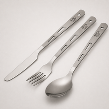 Load image into Gallery viewer, Three-piece titanium cutlery flatware set with engraved handles, including a knife, fork, and spoon, branded APEX. The utensils are arranged diagonally on a light gray background.
