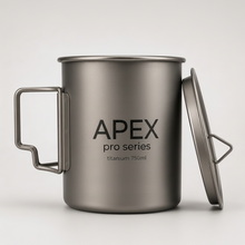 Load image into Gallery viewer, APEX titanium camping 750ml mug with a matching lid leaning against it, featuring folding handles, heat resistant, and set against a clean light gray background.
